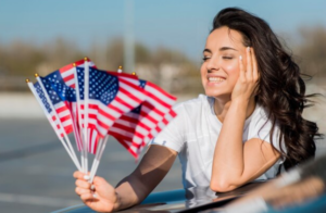 A pretty lady holding American flags